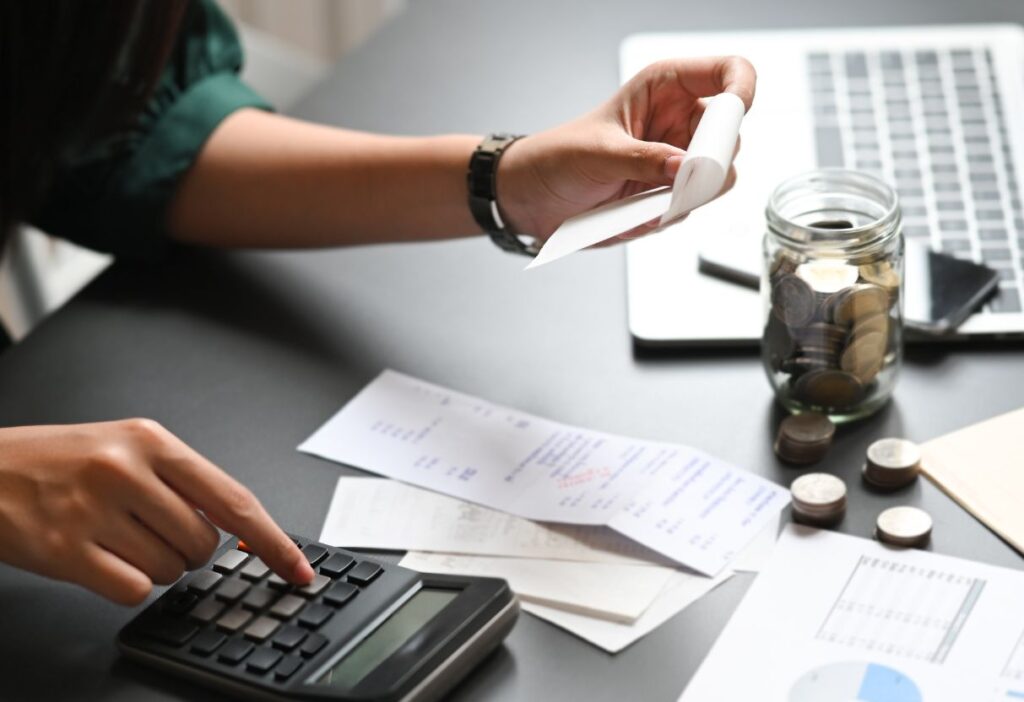 Person making calculations on a calculator, representing personal finances